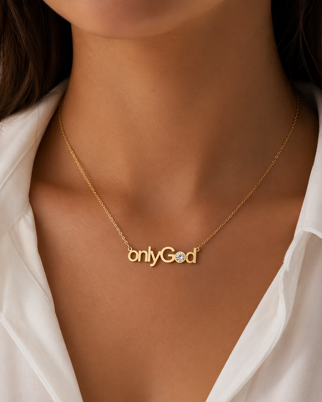 Gold necklace with 'onlyGod' pendant on a person wearing a white shirt.